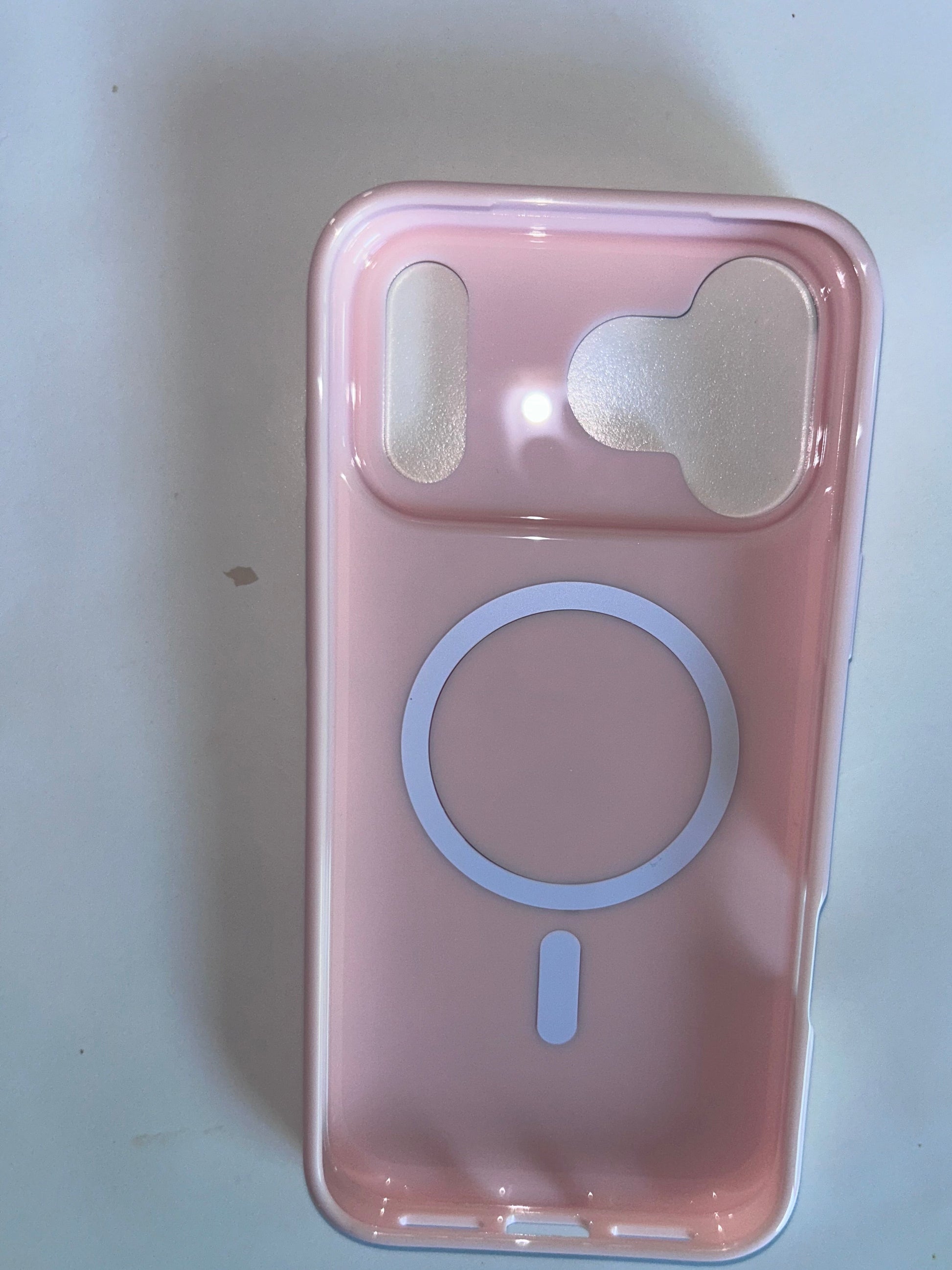 A light pink phone case with a MagSafe-compatible circular ring design, shown from the back on a white surface.